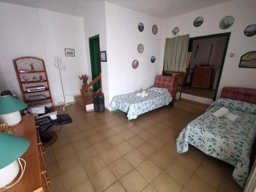 a living room with a couch and a bed and a chair at CASA familiar en un entorno natural en Tenerife Sur in Adeje