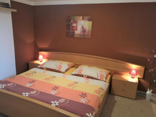 a bedroom with a bed with two lamps on it at Apartma Marcella Liberec in Liberec