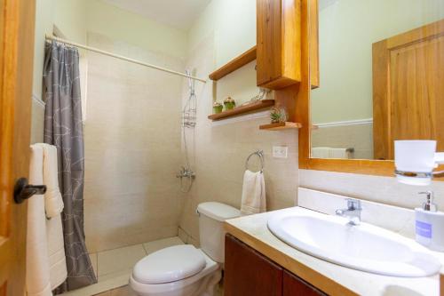 a bathroom with a sink and a toilet and a shower at Beachfront Cadaques Smart Tv Fullkitchenrest in Bayahibe