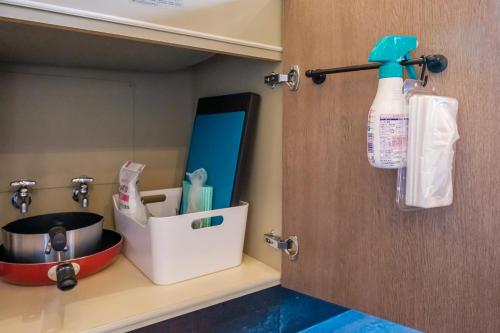 a kitchen cabinet with a sink and a bottle of bleach at MolinHotels407 アクティビティを満喫できる札幌定山渓温泉付き別荘-1L1Room K-Bed1&S-bed3 5persons in Jozankei