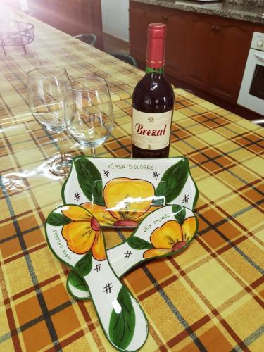 a bottle of wine and a plate with oranges on it at CASA rural DOLORES en Adeje in Adeje