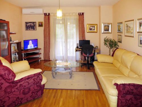 a living room with two couches and a table at Apartment Mira-2 by Interhome in Mirce