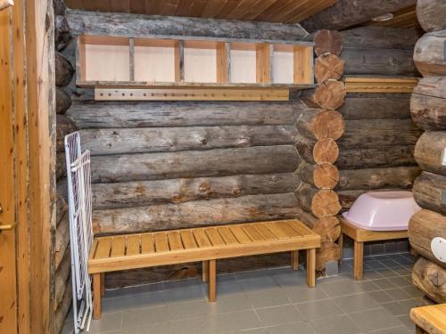 a bathroom with a toilet and a bench at Holiday Home Rukakämmekkä by Interhome in Ruka