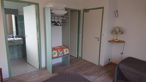 a room with two open doors and a bathroom at Auberge le Cévenol in La Cavalerie