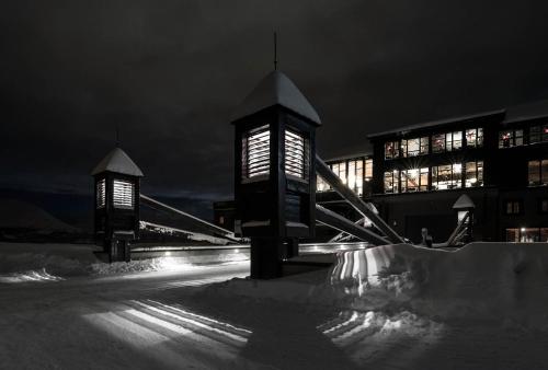 a building with two lights in the snow at night at Skigaarden in Hemsedal