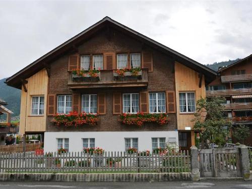 a house with windows and a fence in front of it at Apartment Beatrice by Interhome in Zweisimmen