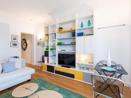 a living room with a couch and a tv at Studio Regina by Interhome in Biarritz