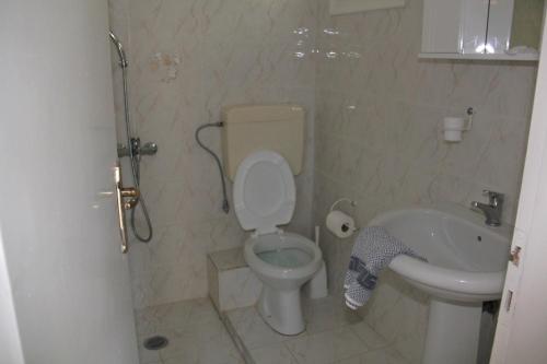 a bathroom with a toilet and a sink at Theodora Studios in Yenion