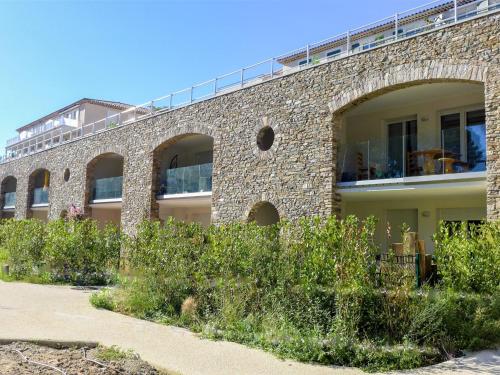 a brick building with a balcony on top of it at Apartment Le Domaine-1 by Interhome in Cavalaire-sur-Mer