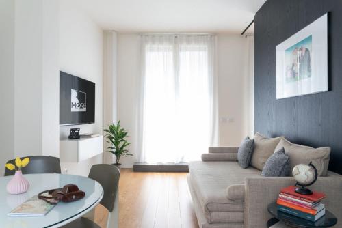 a living room with a couch and a table at BMORE Duomo - Luxury Apartments near Duomo in Milan