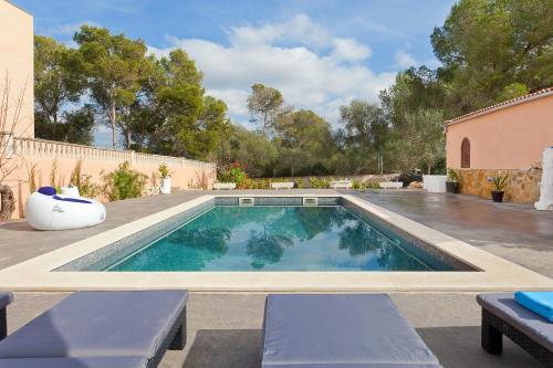 a swimming pool in the backyard of a house at Villa Angela in Urbanicacion ses palmeres