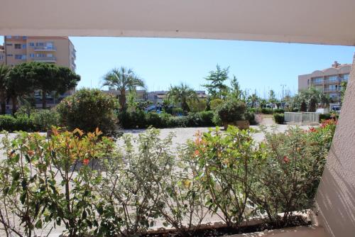 a view of a park with trees and bushes at Holidays Hyeres in Hyères