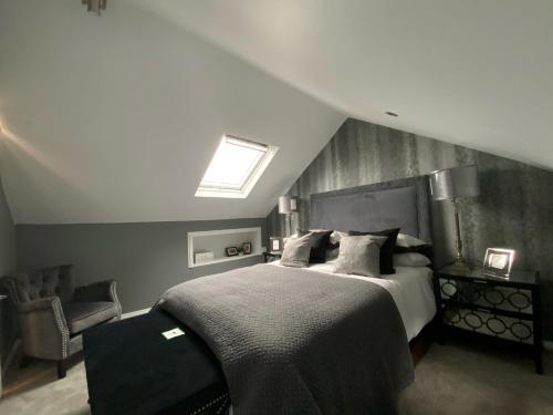 a bedroom with a large bed and a skylight at 5 Star, Boutique Victorian,Entire 3 bedroom hse ,STH LONDON in Catford