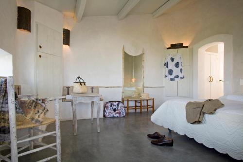 a bedroom with a bed and a table and a desk at Lodge Sainte Helene Adult only in Saintes-Maries-de-la-Mer