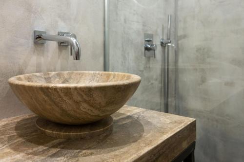a bathroom with a bowl sink and a shower at Guest House de la Valette in Valletta