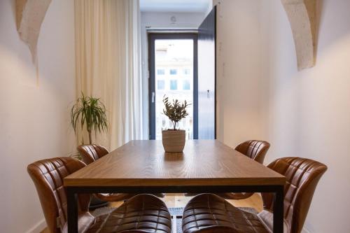 a dining room table with chairs and a plant on it at Guest House de la Valette in Valletta