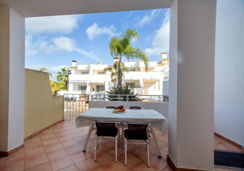 a table and chairs on a balcony with a building at Villa Albufeira by Atlantic Places in Albufeira