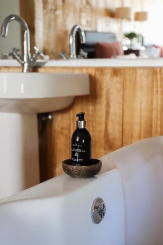 a bottle of soap sitting on the side of a sink at Big Sky Ranch in Colesberg