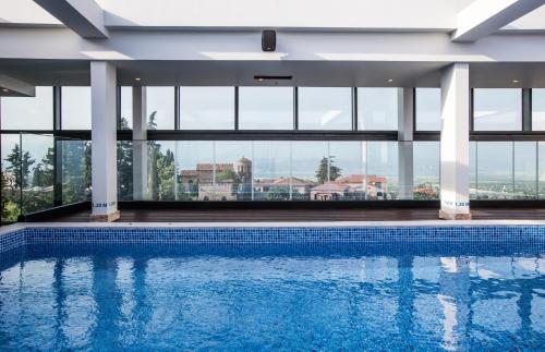 a swimming pool with a view of a building at Holiday Inn Telavi by IHG in Tʼelavi