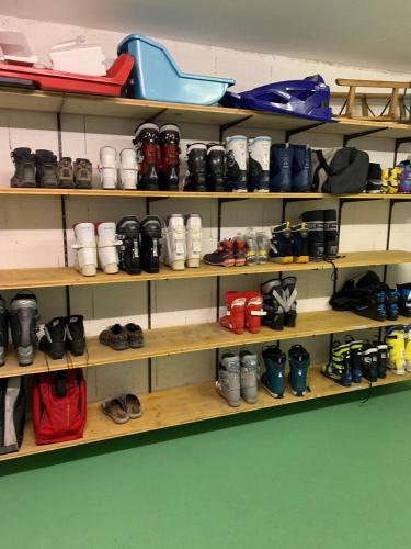 a shelf filled with lots of shoes at Davos Lodge by Quokka 360 - practical apartment for skiers in Davos