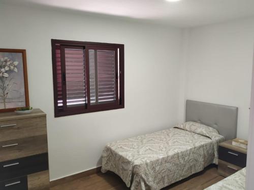 a bedroom with a bed and a window at Punta Negra in Puerto de Santiago