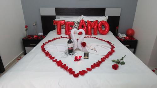 a bed with a heart made out of roses at Hotel Tababela Land in Tababela
