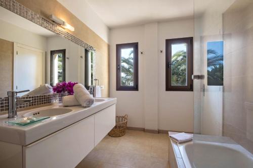 a bathroom with a sink and a tub and a mirror at La Casita in Adeje