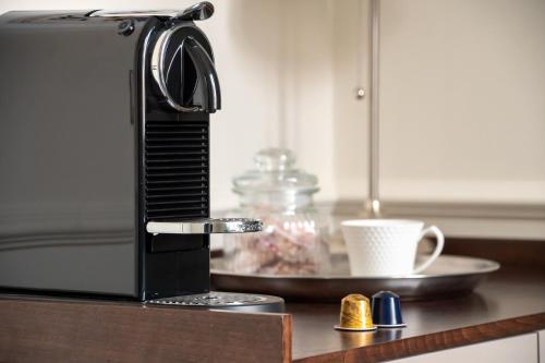 a microwave oven sitting on a counter with a cup of coffee at Longo Suites in Taormina