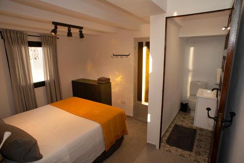 a small bedroom with a bed and a bathroom at Casa Calma Moraira in Moraira