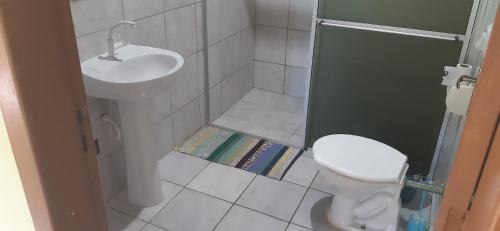a small bathroom with a sink and a toilet at JOÃO CARLOS CASAS 3 Quartos Penha SC in Penha