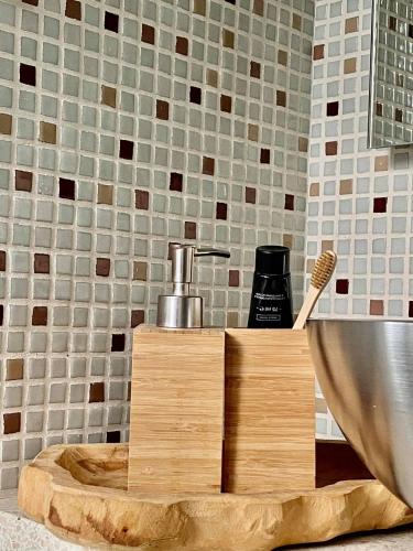 a bathroom with a sink with a wooden cutting board at Casa De Palmas - Tiny house in Alkmaar