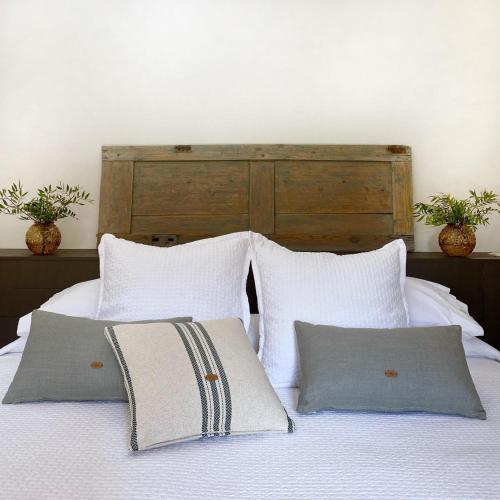 a bed with white sheets and pillows in a bedroom at Mas Ferran Adults Only in Pals