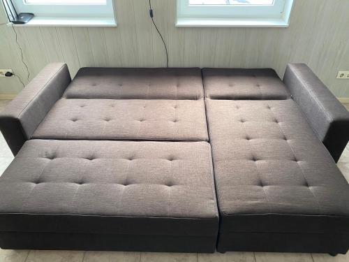 a brown couch sitting in a living room at Urmas Rehvid Holiday Home in Põlva