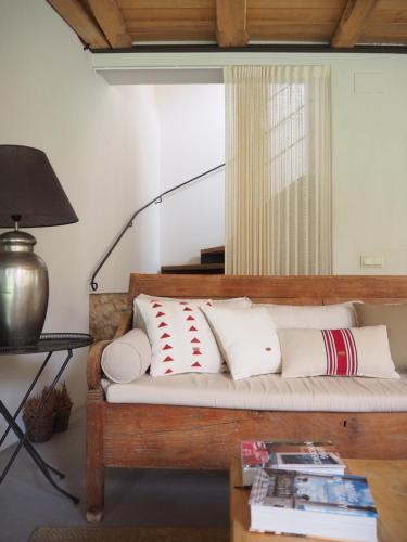 a couch with pillows on it in a room at Mas Ferran Adults Only in Pals