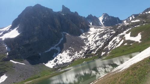 a mountain with snow on it and a lake at Aiguille Noire in Valloire