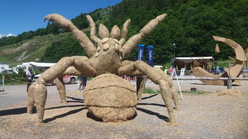 a statue of a giant spider sitting on the ground at Aiguille Noire in Valloire