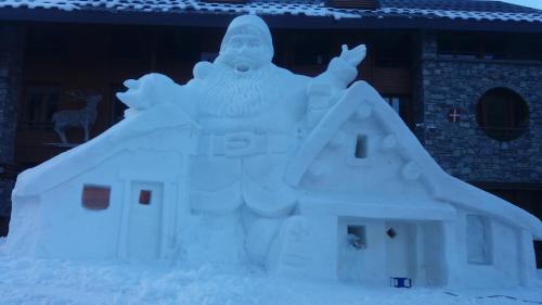 a snow sculpture of a god in front of a house at Aiguille Noire in Valloire