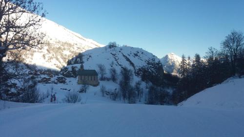 a snow covered mountain with a small building on it at Aiguille Noire in Valloire