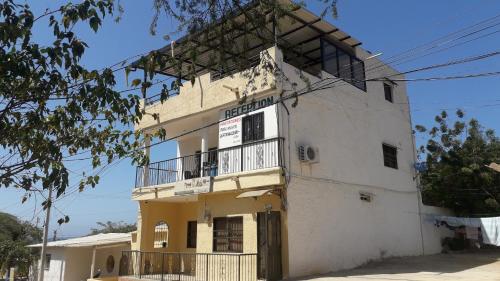 an old white building with a balcony at Hostal Casa Yhoanny in Taganga