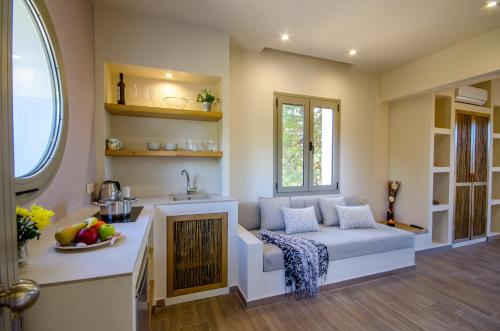 een woonkamer met een bank en een open haard bij Forest Resort Suites Skiathos in Troulos