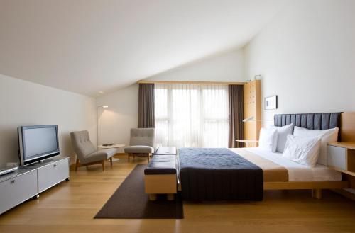 a hotel room with a bed and a television at The Omnia in Zermatt