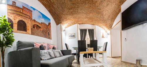 a living room with a couch and a table at Art & SUITE Apartment Cáceres in Cáceres