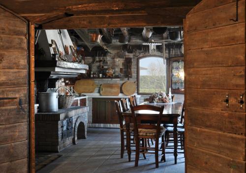 a dining room with a table and chairs in a kitchen at Red Fenice in San Donà di Piave