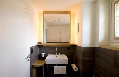a bathroom with a sink and a mirror at The Omnia in Zermatt