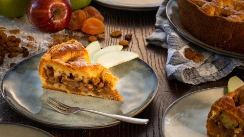 a slice of apple pie on a plate with a fork at Curaçao Gardens in Willemstad