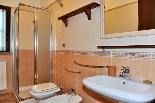 a bathroom with a sink and a toilet and a shower at Agriturismo Bocci in Castiglione della Pescaia