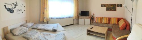 a living room with a couch and a table at Ferienwohnung Sonnenberg Dahmeblick in Märkisch Buchholz