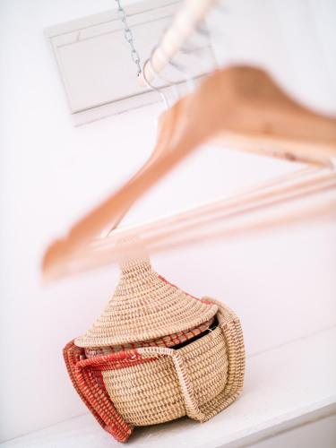 a rattan basket hanging on a shelf at Casa Blu Guesthouse - Casa de Hospedes in Santa Maria