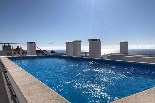 a large swimming pool on top of a building at North Breeze - 2 Bedroom Apartment with Rooftop Pool in Nazaré