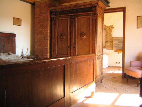 a large wooden cabinet in a living room at Agriturismo il Casalino in Pari